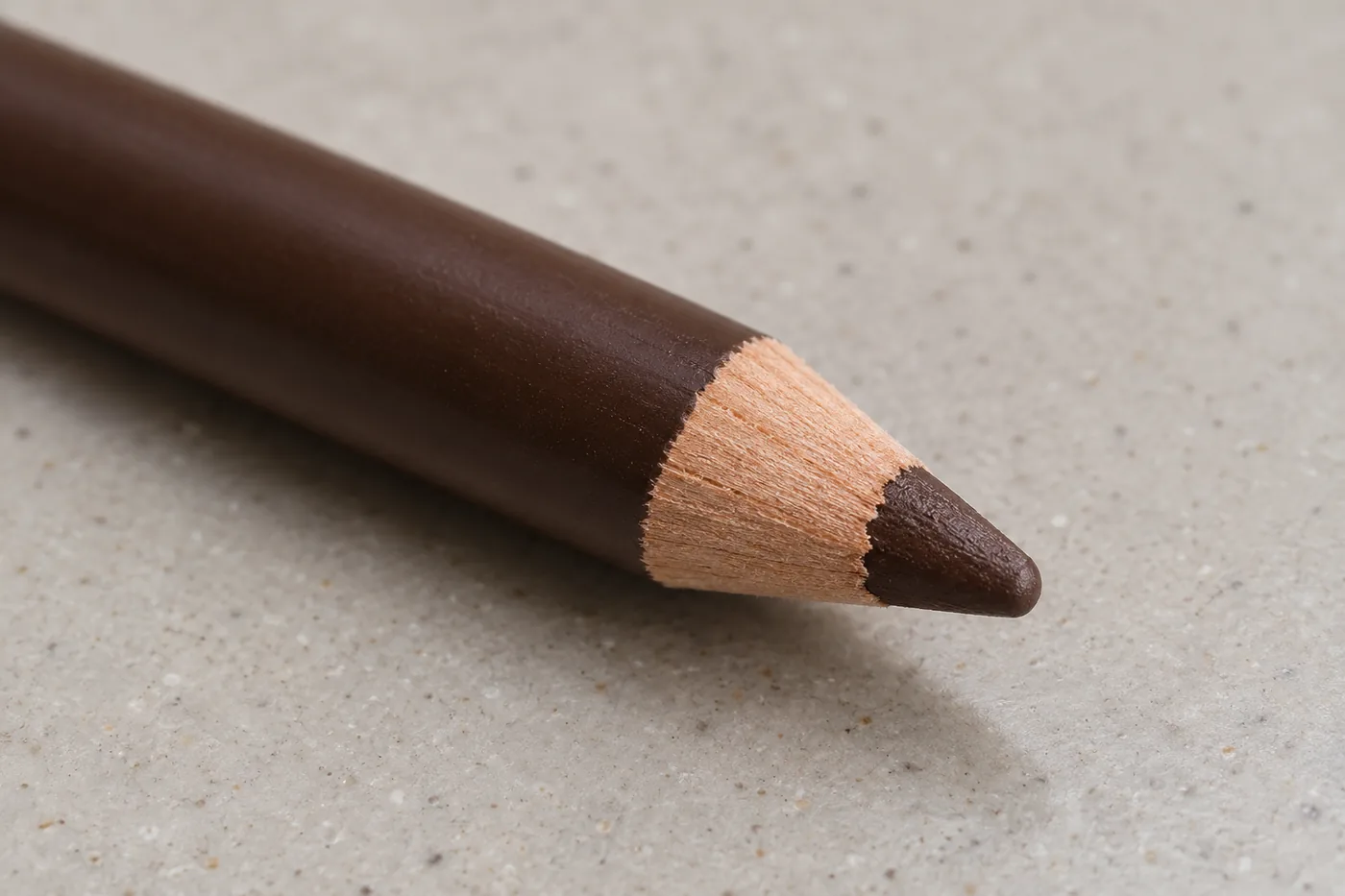 Close view of a wooden pencil taper surrounding a short rounded brown core